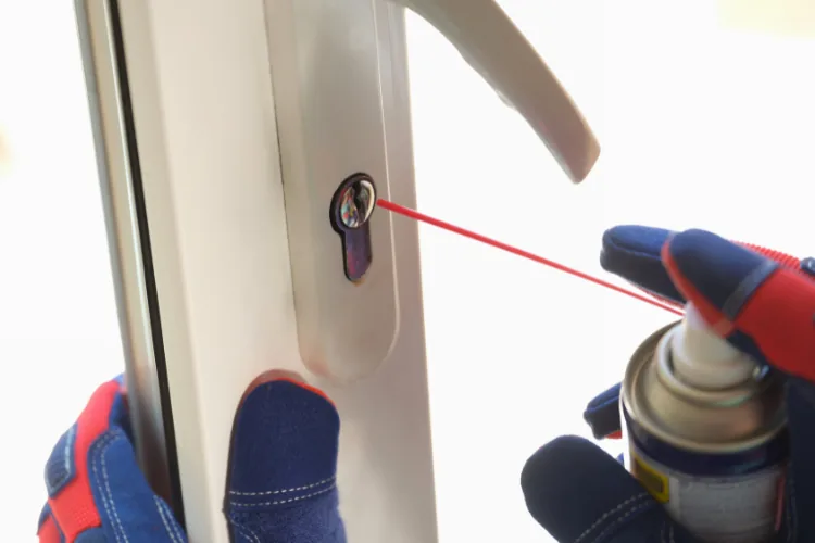 Cleaning and lubricating a door lock to improve latching