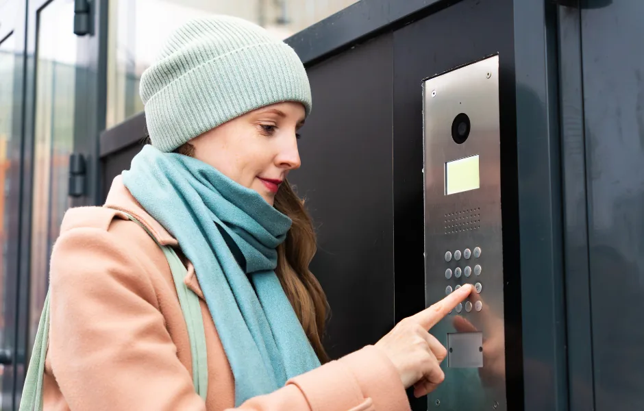 In-unit video intercom station showing live camera feed of a visitor at the door