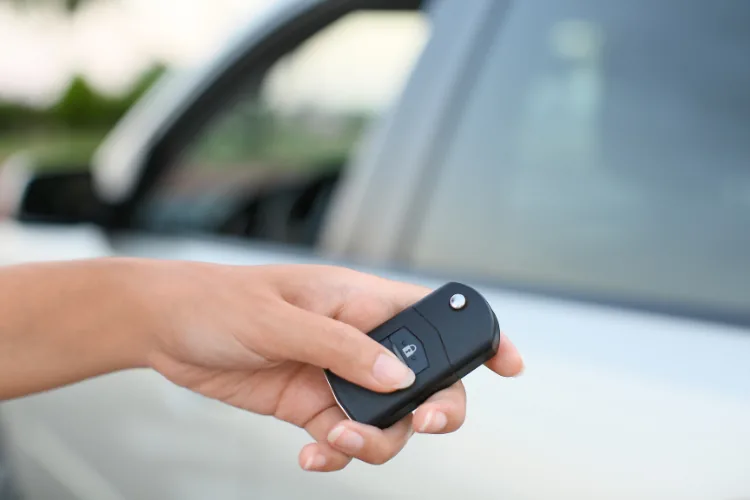 Close-up of a car key fob with its buttons and battery compartment