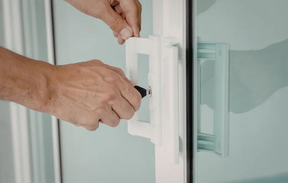 Locksmith removing a deadbolt cylinder from a door in NYC