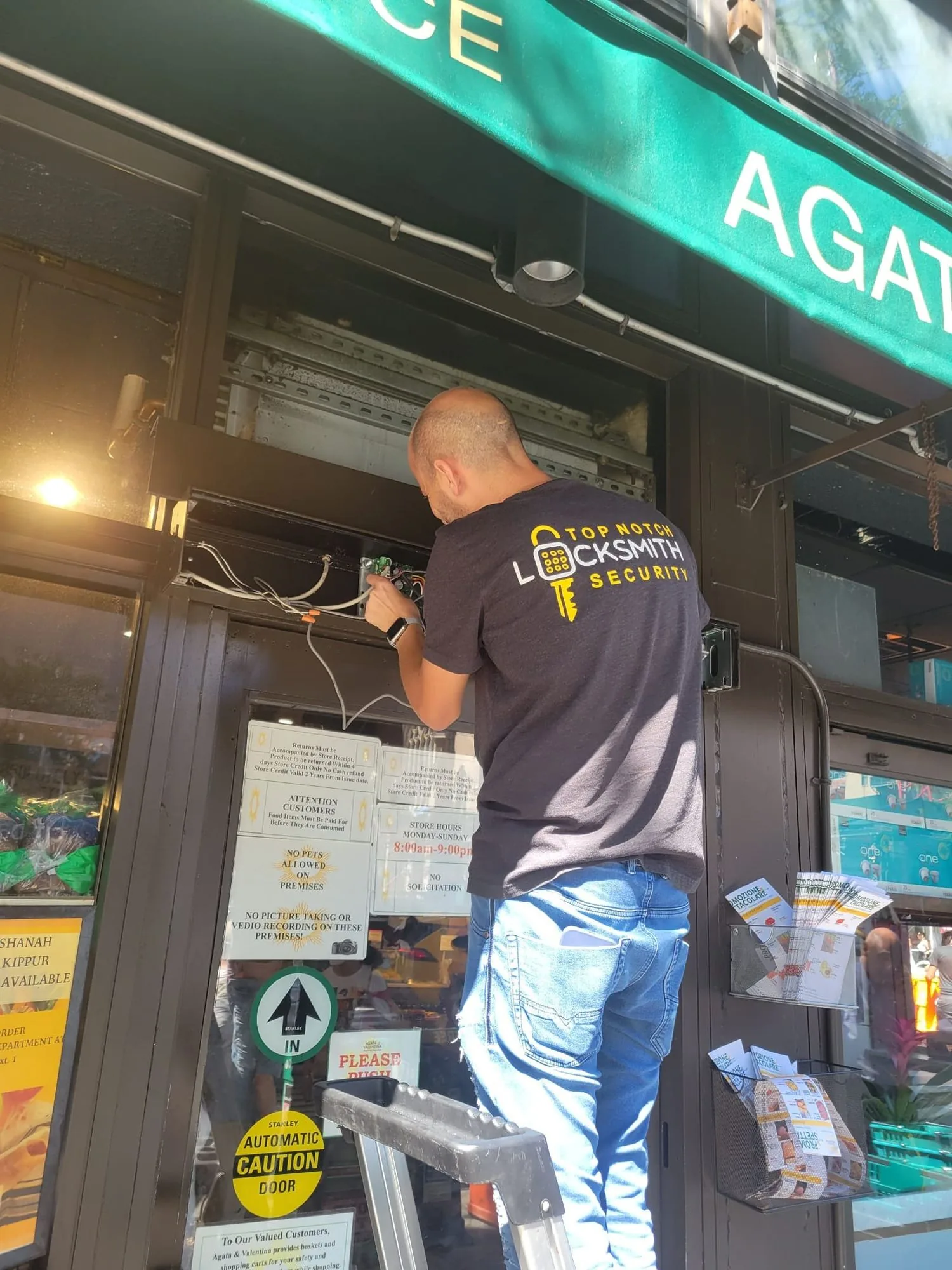 Top Notch Locksmith & Security technician wiring an automatic storefront door in New York City