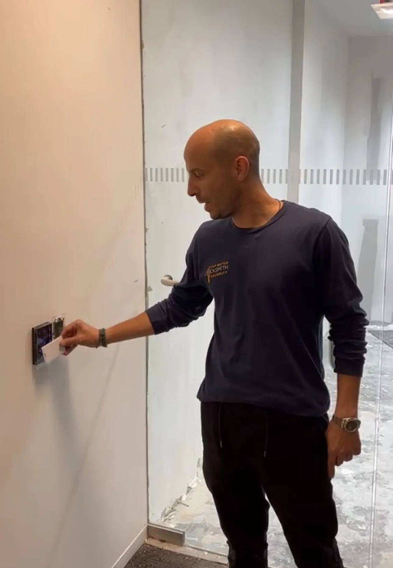 Top Notch Locksmith & Security technician programming an access control reader at an NYC office