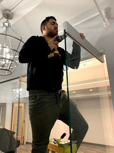 Top Notch technician servicing a commercial storefront door in NYC