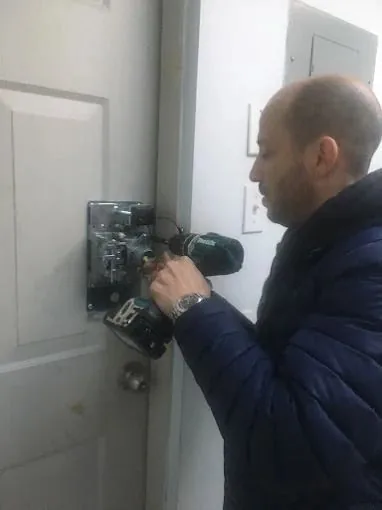 Top Notch Locksmith technician working on a residential door lock in NYC